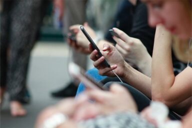 Carolina car shoppers researching dealerships on their phones
